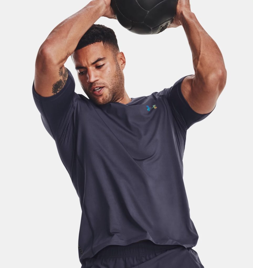 Man working out with exercise ball or medicine ball above his head