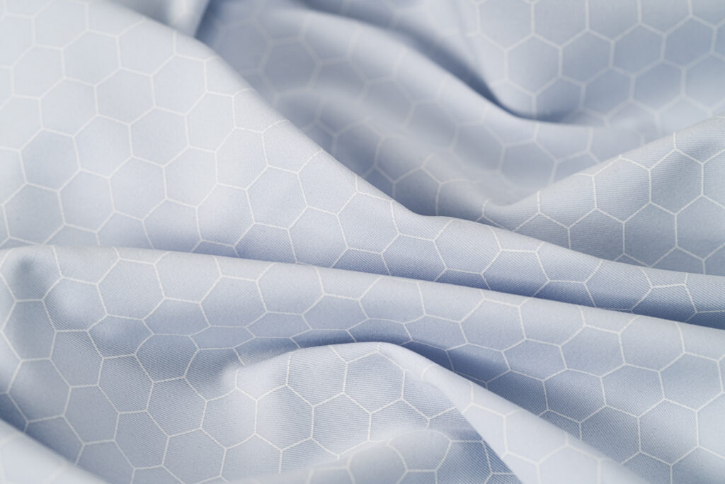 Close-up of white fabric with hexagon pattern