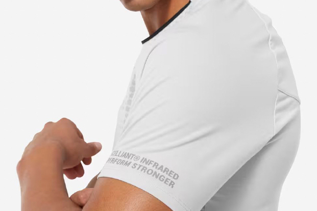 Close-up of a white athletic shirt sleeve with 'CELLIANT INFRARED PERFORM STRONGER' text printed in gray along the hem.