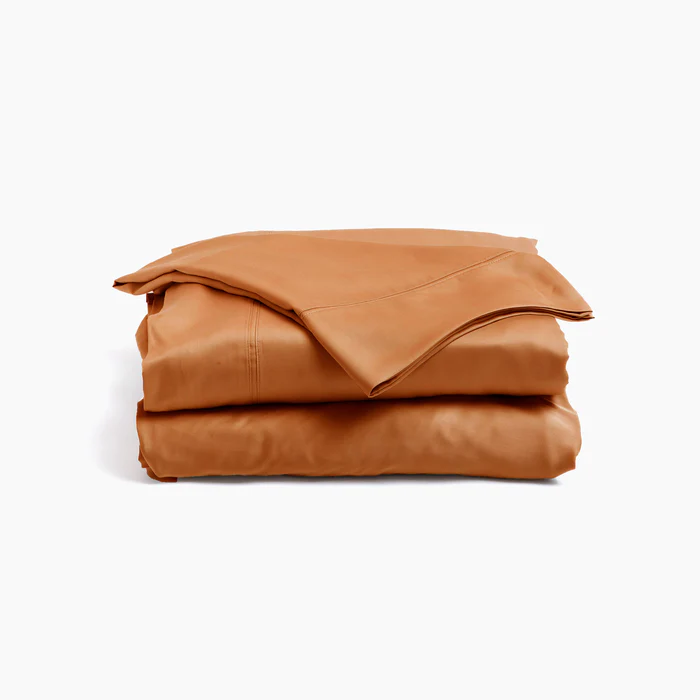 Stack of terra cotta colored bed sheets